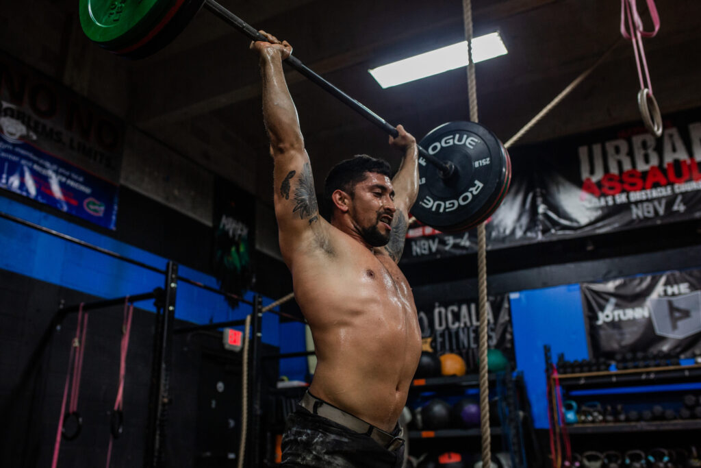 Athlete training overhead strength as part of a sports performance program at Iron Legion Ocala