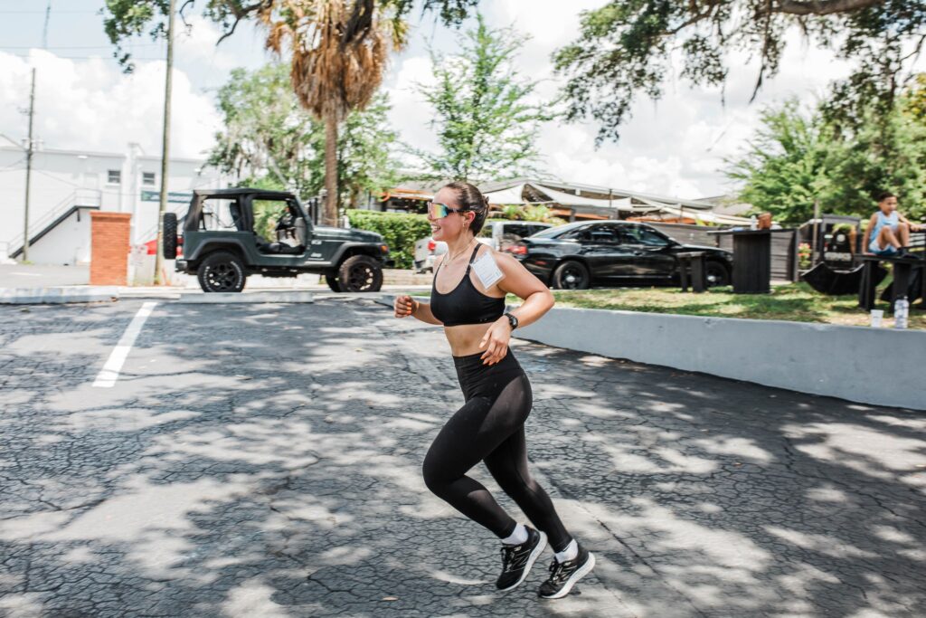 Female athlete running through a parking lot during the Rox Race at Iron Legion Strength and Combat in Ocala Florida